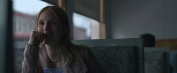 Movie still from “The Good Nurse” (2022), directed by Tobias Lindholm – A woman sitting on a bench in the dark; Close Up shot, Over the shoulder angle