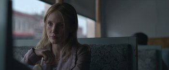 Movie still from “The Good Nurse” (2022), directed by Tobias Lindholm – A woman sitting on a bench in the dark; Close Up shot, Over the shoulder angle