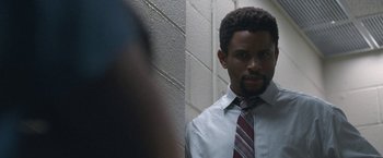 Movie still from “The Good Nurse” (2022), directed by Tobias Lindholm – A man wearing a white dress shirt and a red striped tie; Close Up shot, Over the shoulder angle