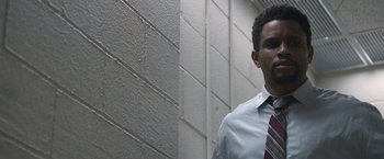 Movie still from “The Good Nurse” (2022), directed by Tobias Lindholm – A man wearing a white dress shirt and a red tie; Close Up shot, Low angle