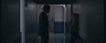 Movie still from “The Good Nurse” (2022), directed by Tobias Lindholm – A man in a suit and tie in a hallway; Medium shot, Over the shoulder angle