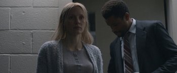 Movie still from “The Good Nurse” (2022), directed by Tobias Lindholm – A woman standing next to a man wearing a suit; Close Up shot, Over the shoulder angle