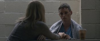 Movie still from “The Good Nurse” (2022), directed by Tobias Lindholm – A man and a woman sitting in front of each other; Close Up shot, Over the shoulder angle