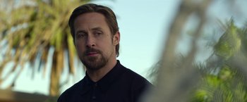 Movie still from “The Gray Man” (2022), directed by Joe Russo – A person wearing a black shirt; Close Up shot, Over the shoulder angle