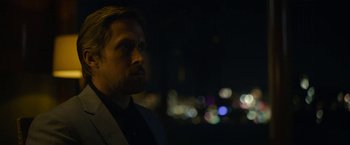 Movie still from “The Gray Man” (2022), directed by Joe Russo – A person wearing a suit and tie; Close Up shot, Over the shoulder angle