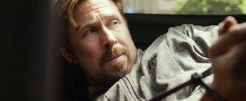 Movie still from “The Gray Man” (2022), directed by Joe Russo – A person with a beard; Close Up shot, Over the shoulder angle