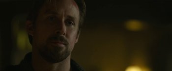 Movie still from “The Gray Man” (2022), directed by Joe Russo – A person wearing a black shirt; Close Up shot, Over the shoulder angle