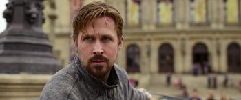 Movie still from “The Gray Man” (2022), directed by Joe Russo – A person wearing a jacket; Close Up shot, Over the shoulder angle