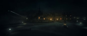 Movie still from “The Gray Man” (2022), directed by Joe Russo – A night scene of an old building in the middle of the night; Extreme Wide shot, High angle