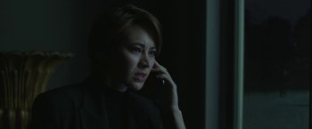 Movie still from “The Gray Man” (2022), directed by Joe Russo – A woman talking on a cell phone in the dark; Close Up shot, Low angle