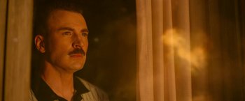 Movie still from “The Gray Man” (2022), directed by Joe Russo – A person wearing a shirt; Close Up shot, Low angle