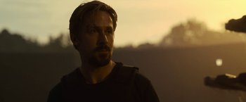 Movie still from “The Gray Man” (2022), directed by Joe Russo – A person wearing a black shirt; Close Up shot, Over the shoulder angle