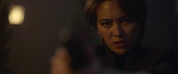 Movie still from “The Gray Man” (2022), directed by Joe Russo – A woman's face in the dark; Close Up shot, Low angle