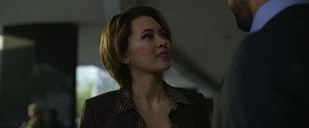 Movie still from “The Gray Man” (2022), directed by Joe Russo – A person with short hair wearing a jacket; Close Up shot, Over the shoulder angle