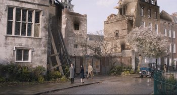 Movie still from “The Guernsey Literary and Potato Peel Pie Society” (2018), directed by Mike Newell – A group of people standing on the side of a road; Extreme Wide shot, High angle