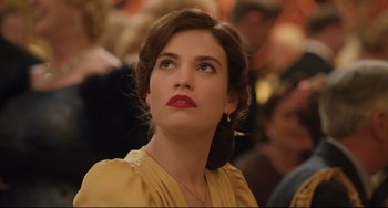 Movie still from “The Guernsey Literary and Potato Peel Pie Society” (2018), directed by Mike Newell – A person wearing a yellow shirt; Close Up shot, Over the shoulder angle