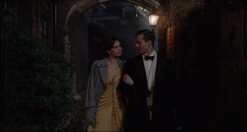 Movie still from “The Guernsey Literary and Potato Peel Pie Society” (2018), directed by Mike Newell – A man and a woman dressed in evening wear; Medium shot, Low angle