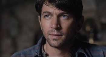 Movie still from “The Guernsey Literary and Potato Peel Pie Society” (2018), directed by Mike Newell – A person wearing a plaid shirt; Close Up shot, Over the shoulder angle