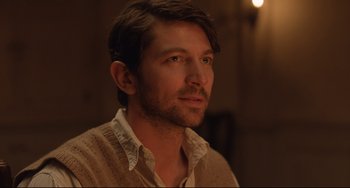 Movie still from “The Guernsey Literary and Potato Peel Pie Society” (2018), directed by Mike Newell – A person wearing a sweater; Close Up shot, Over the shoulder angle