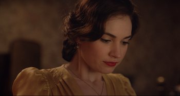 Movie still from “The Guernsey Literary and Potato Peel Pie Society” (2018), directed by Mike Newell – A person wearing a yellow dress; Close Up shot, Over the shoulder angle