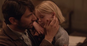 Movie still from “The Guernsey Literary and Potato Peel Pie Society” (2018), directed by Mike Newell – A man and a little girl are kissing each other; Close Up shot, Over the shoulder angle