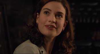 Movie still from “The Guernsey Literary and Potato Peel Pie Society” (2018), directed by Mike Newell – A person with a nose ring; Close Up shot, Over the shoulder angle