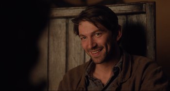 Movie still from “The Guernsey Literary and Potato Peel Pie Society” (2018), directed by Mike Newell – A person smiling for a picture; Close Up shot, Over the shoulder angle