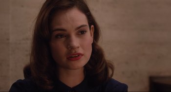 Movie still from “The Guernsey Literary and Potato Peel Pie Society” (2018), directed by Mike Newell – A person wearing a blue shirt; Close Up shot, Over the shoulder angle