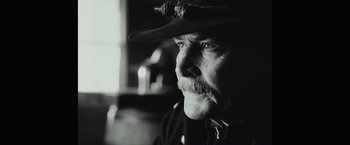 Movie still from “Once Upon a Time in Hollywood” (2019), directed by Quentin Tarantino – An older man wearing a cowboy hat looking at the camera; Close Up shot, Over the shoulder angle