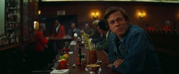 Movie still from “Once Upon a Time in Hollywood” (2019), directed by Quentin Tarantino – A man sitting at a table in front of a bloody mary; Close Up shot, Over the shoulder angle
