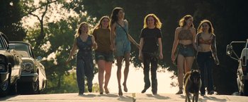Movie still from “Once Upon a Time in Hollywood” (2019), directed by Quentin Tarantino – A group of young women walking across a bridge; Wide shot, Low angle