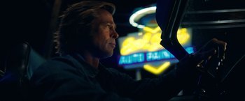 Movie still from “Once Upon a Time in Hollywood” (2019), directed by Quentin Tarantino – A man sitting in a car at night looking out the window; Close Up shot, Low angle