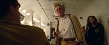 Movie still from “Once Upon a Time in Hollywood” (2019), directed by Quentin Tarantino – An older man wearing glasses and wearing a sweater; Medium shot, Low angle