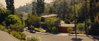 Movie still from “Once Upon a Time in Hollywood” (2019), directed by Quentin Tarantino – A house with a car parked on the side of the road; Extreme Wide shot, High angle