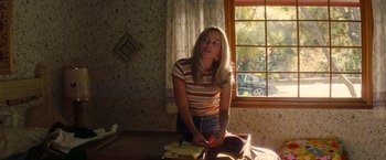 Movie still from “Once Upon a Time in Hollywood” (2019), directed by Quentin Tarantino – A woman sitting on the floor in front of a window; Medium shot, Over the shoulder angle