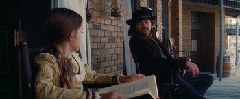 Movie still from “Once Upon a Time in Hollywood” (2019), directed by Quentin Tarantino – A man and a little girl sitting next to each other; Medium shot, Over the shoulder angle