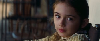 Movie still from “Once Upon a Time in Hollywood” (2019), directed by Quentin Tarantino – A young girl's face looking at the camera; Close Up shot, Over the shoulder angle