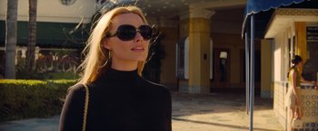 Movie still from “Once Upon a Time in Hollywood” (2019), directed by Quentin Tarantino – A woman wearing sunglasses and a black top; Close Up shot, Low angle