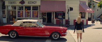 Movie still from “Once Upon a Time in Hollywood” (2019), directed by Quentin Tarantino – A red car parked on the side of the street; Wide shot, High angle