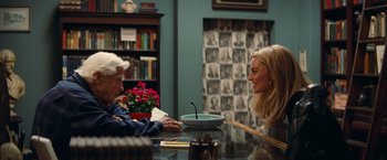 Movie still from “Once Upon a Time in Hollywood” (2019), directed by Quentin Tarantino – Two women sitting at a table talking to each other; Medium shot, Over the shoulder angle