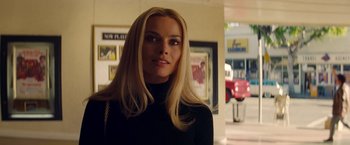 Movie still from “Once Upon a Time in Hollywood” (2019), directed by Quentin Tarantino – A woman with long blonde hair wearing a black sweater; Close Up shot, Over the shoulder angle