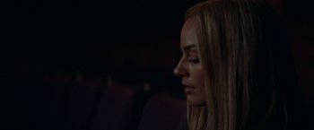 Movie still from “Once Upon a Time in Hollywood” (2019), directed by Quentin Tarantino – A beautiful blonde woman sitting in a theater; Close Up shot, Over the shoulder angle