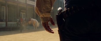 Movie still from “Once Upon a Time in Hollywood” (2019), directed by Quentin Tarantino – A man holding his hand out to a horse; Close Up shot, Low angle