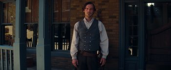 Movie still from “Once Upon a Time in Hollywood” (2019), directed by Quentin Tarantino – A man standing in front of a brick building; Medium shot, Over the shoulder angle