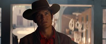 Movie still from “Once Upon a Time in Hollywood” (2019), directed by Quentin Tarantino – A man wearing a cowboy hat and ear phones; Close Up shot, Over the shoulder angle