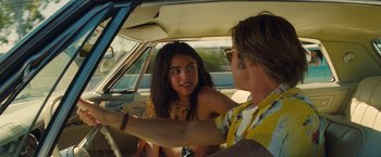 Movie still from “Once Upon a Time in Hollywood” (2019), directed by Quentin Tarantino – A man and a woman sitting in the drivers seat of a car; Close Up shot, Over the shoulder angle