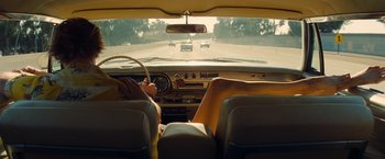 Movie still from “Once Upon a Time in Hollywood” (2019), directed by Quentin Tarantino – A view from inside of a car of the inside of a car; Wide shot, Low angle