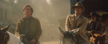 Movie still from “Once Upon a Time in Hollywood” (2019), directed by Quentin Tarantino – Two men sitting on top of a horse in the fog; Medium shot, Over the shoulder angle