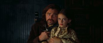 Movie still from “Once Upon a Time in Hollywood” (2019), directed by Quentin Tarantino – A man and a young girl are holding a gun; Close Up shot, Low angle