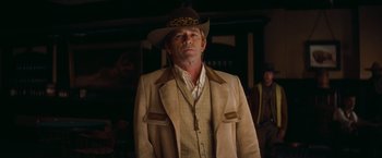 Movie still from “Once Upon a Time in Hollywood” (2019), directed by Quentin Tarantino – A man wearing a cowboy hat and a jacket; Medium shot, Over the shoulder angle